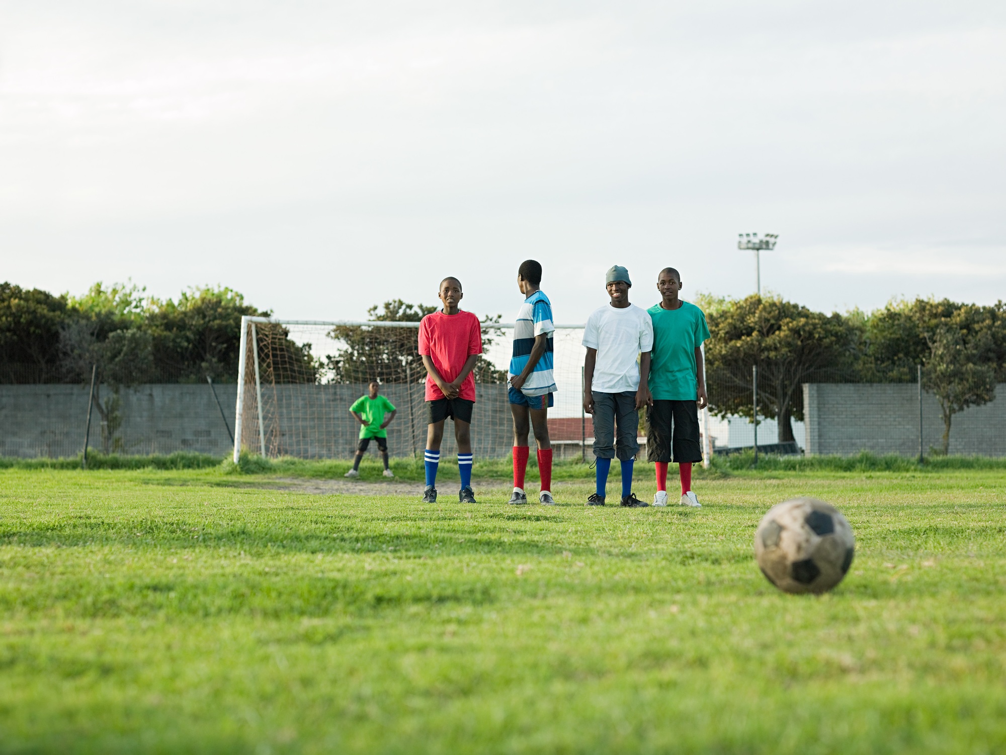 Teenage boys playing football